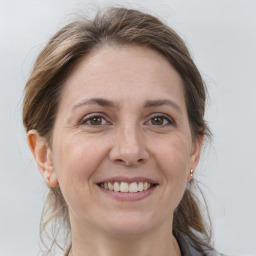 Joyful white adult female with medium  brown hair and grey eyes