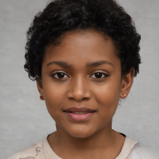 Joyful black child female with short  black hair and brown eyes