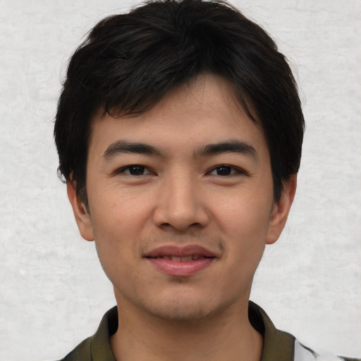 Joyful asian young-adult male with short  black hair and brown eyes