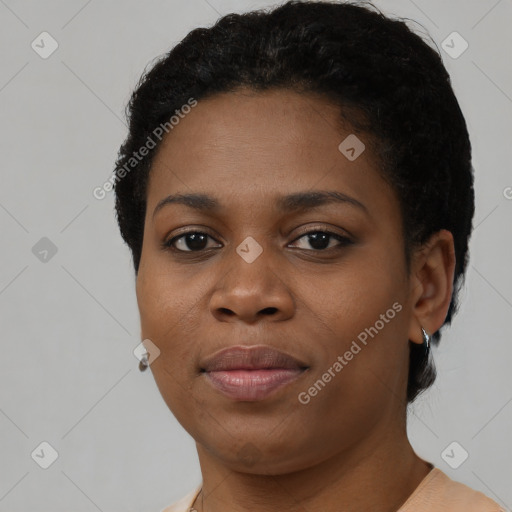 Joyful black young-adult female with short  brown hair and brown eyes