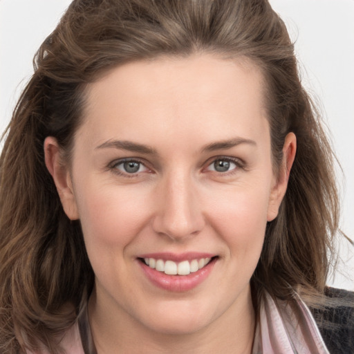 Joyful white young-adult female with long  brown hair and grey eyes