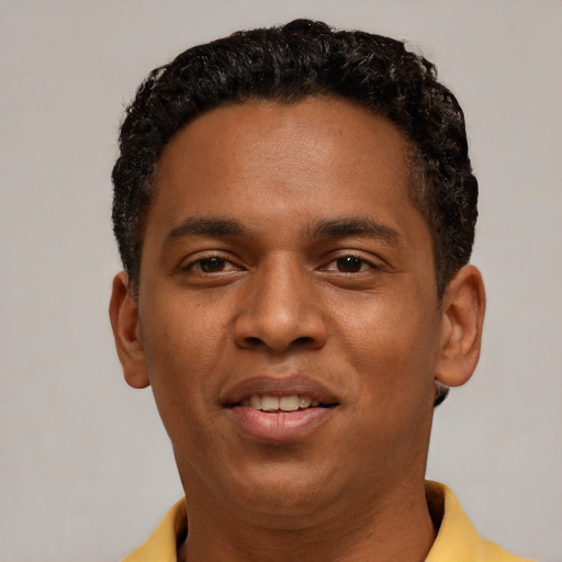Joyful black young-adult male with short  brown hair and brown eyes