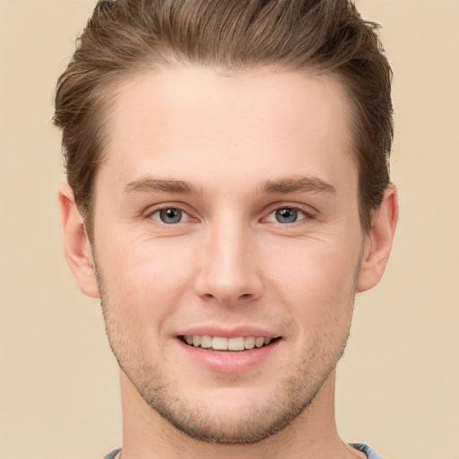 Joyful white young-adult male with short  brown hair and grey eyes