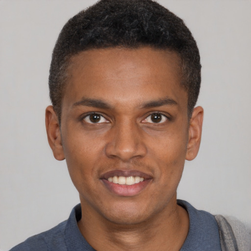 Joyful black young-adult male with short  brown hair and brown eyes