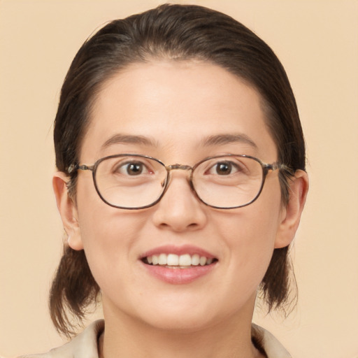 Joyful white adult female with medium  brown hair and brown eyes