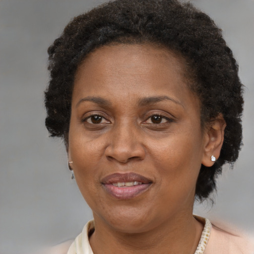 Joyful black adult female with short  brown hair and brown eyes