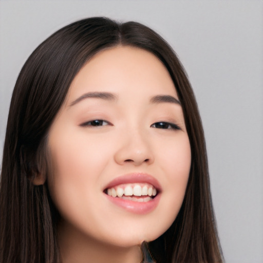 Joyful asian young-adult female with long  brown hair and brown eyes