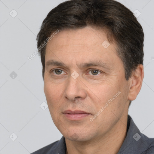 Joyful white adult male with short  brown hair and brown eyes