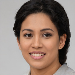 Joyful latino young-adult female with long  brown hair and brown eyes