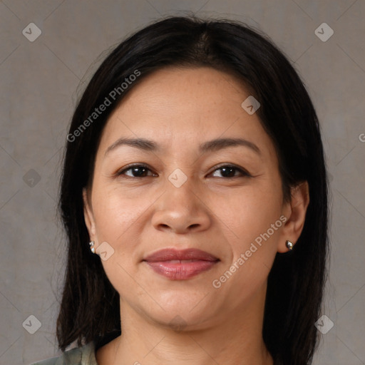 Joyful latino adult female with medium  brown hair and brown eyes