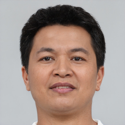 Joyful asian adult male with short  black hair and brown eyes