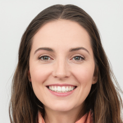 Joyful white young-adult female with long  brown hair and grey eyes