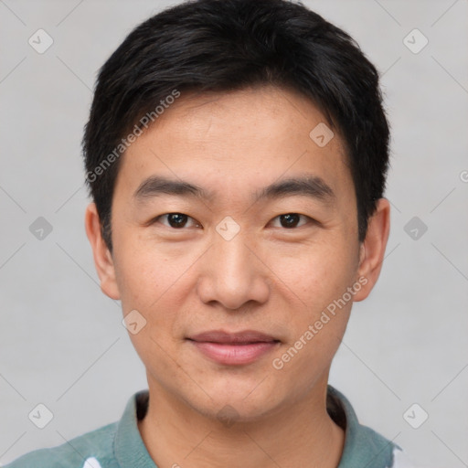 Joyful asian young-adult male with short  black hair and brown eyes