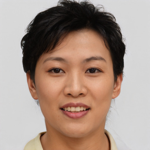 Joyful asian young-adult female with short  brown hair and brown eyes