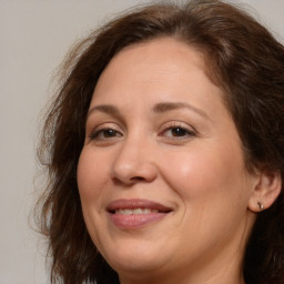 Joyful white adult female with long  brown hair and brown eyes