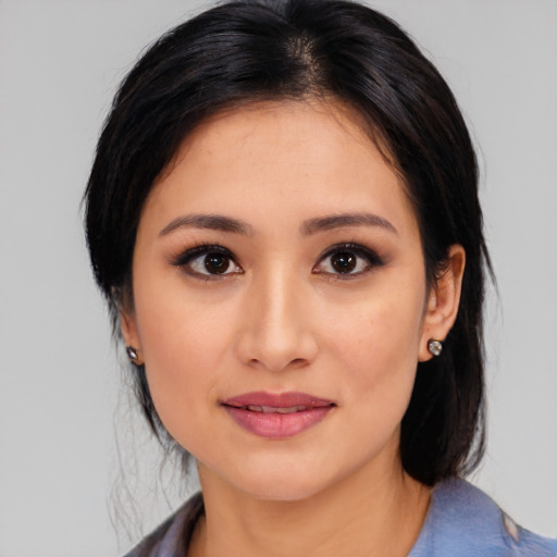 Joyful latino young-adult female with medium  brown hair and brown eyes