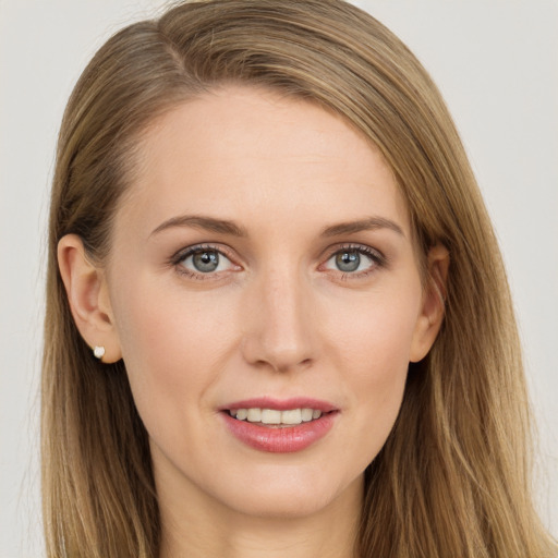 Joyful white young-adult female with long  brown hair and grey eyes