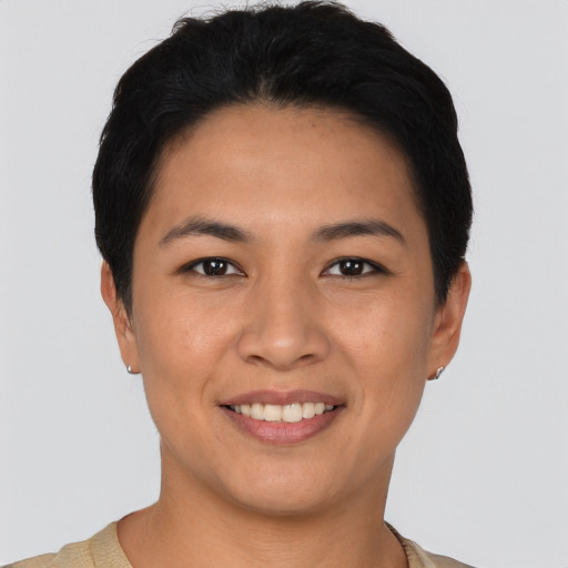 Joyful latino young-adult female with short  black hair and brown eyes