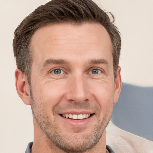 Joyful white adult male with short  brown hair and grey eyes