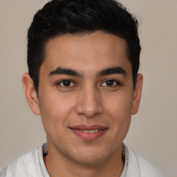 Joyful latino young-adult male with short  brown hair and brown eyes