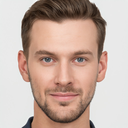 Joyful white young-adult male with short  brown hair and grey eyes