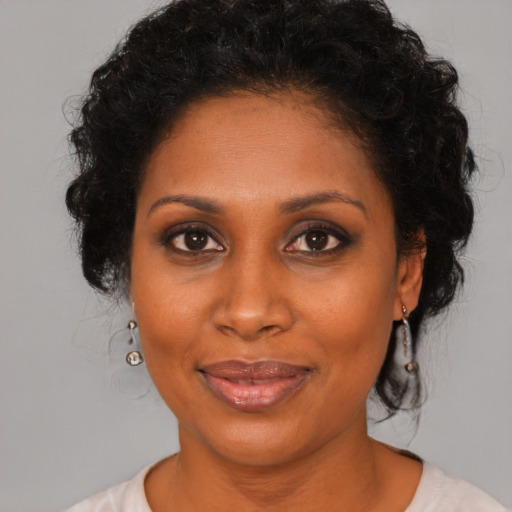 Joyful black young-adult female with medium  brown hair and brown eyes