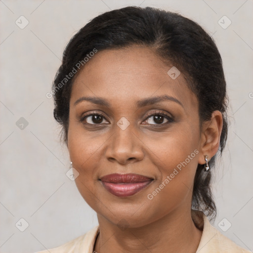 Joyful black adult female with medium  brown hair and brown eyes