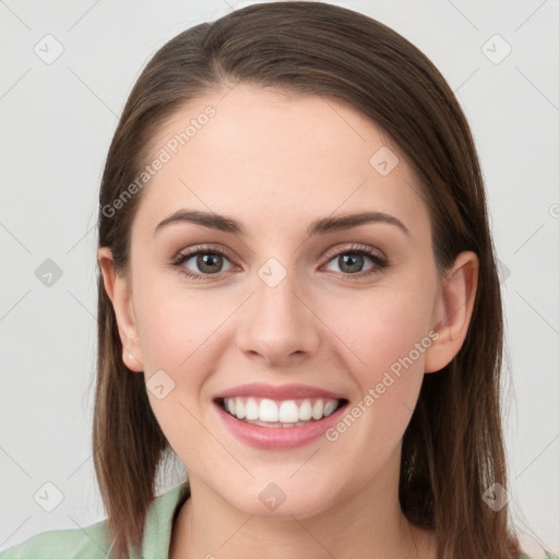 Joyful white young-adult female with long  brown hair and grey eyes