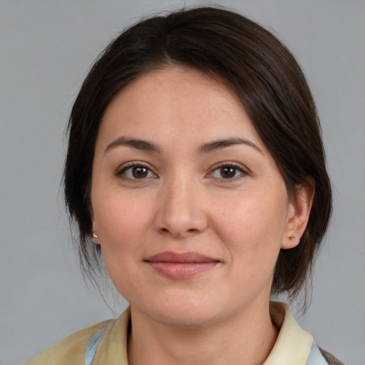 Joyful white young-adult female with medium  brown hair and brown eyes