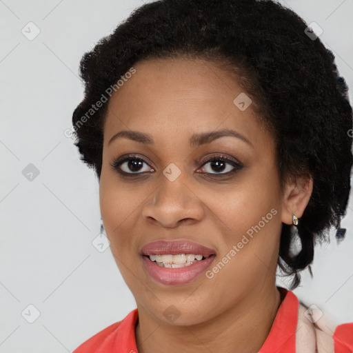 Joyful black young-adult female with long  brown hair and brown eyes