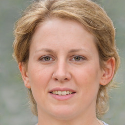 Joyful white young-adult female with medium  brown hair and green eyes