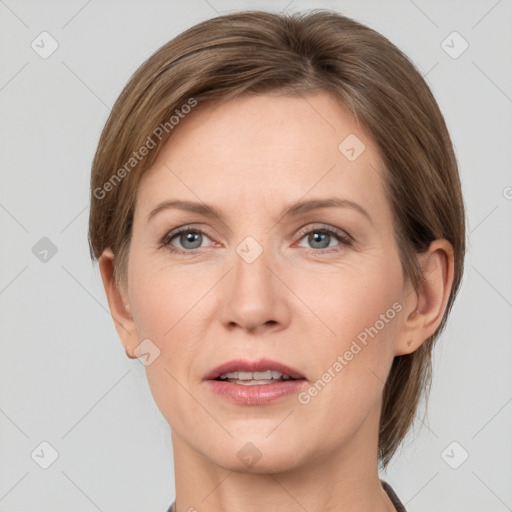 Joyful white adult female with medium  brown hair and grey eyes