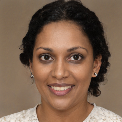Joyful black young-adult female with medium  black hair and brown eyes