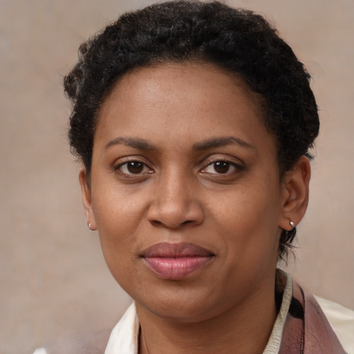 Joyful black adult female with short  brown hair and brown eyes