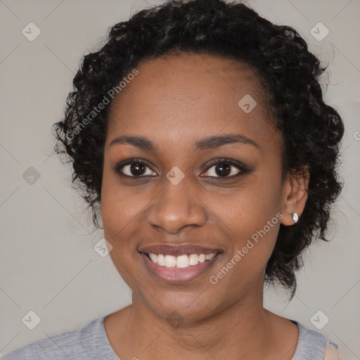 Joyful black young-adult female with short  black hair and brown eyes