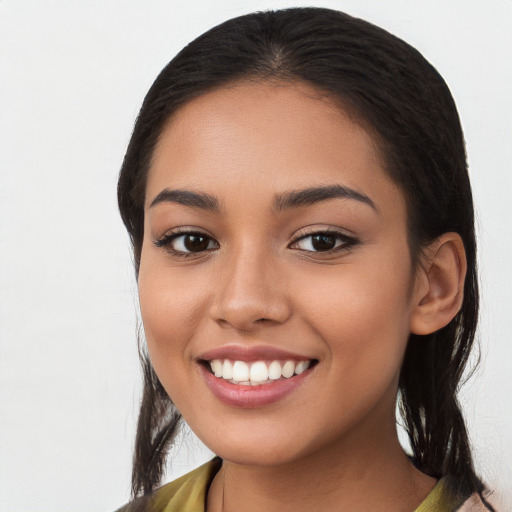 Joyful latino young-adult female with long  black hair and brown eyes