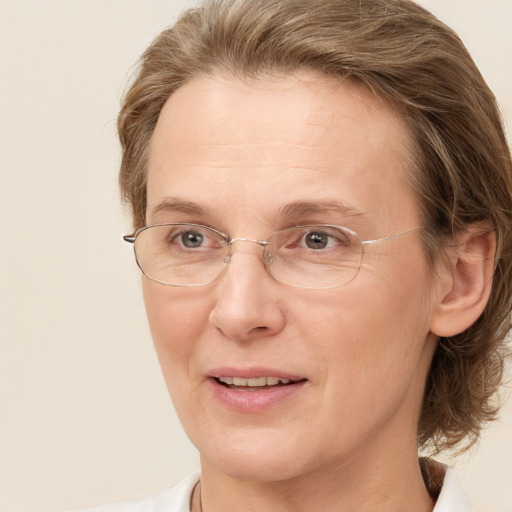 Joyful white adult female with medium  brown hair and blue eyes