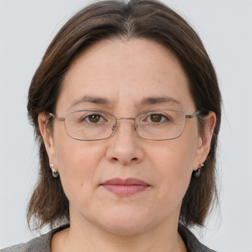 Joyful white adult female with medium  brown hair and grey eyes