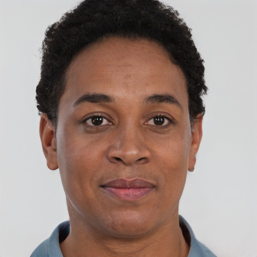 Joyful black adult female with short  brown hair and brown eyes