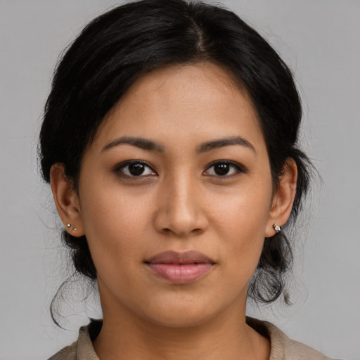 Joyful latino young-adult female with medium  brown hair and brown eyes