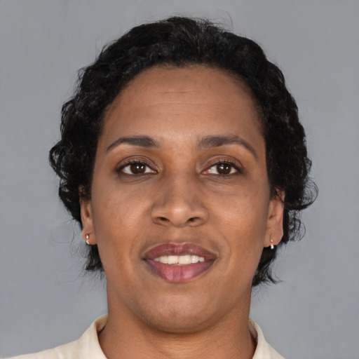 Joyful black young-adult female with short  brown hair and brown eyes