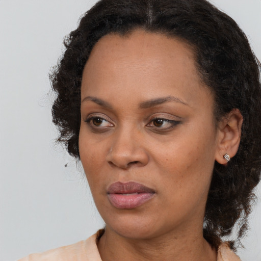 Joyful black adult female with medium  black hair and brown eyes