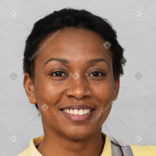 Joyful black young-adult female with short  black hair and brown eyes