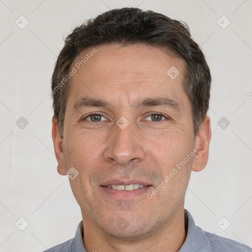 Joyful white adult male with short  brown hair and brown eyes