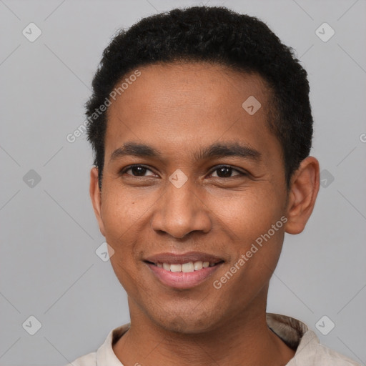 Joyful latino young-adult male with short  black hair and brown eyes