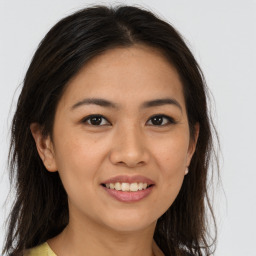 Joyful white young-adult female with long  brown hair and brown eyes