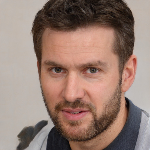 Joyful white adult male with short  brown hair and brown eyes