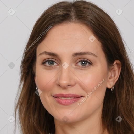 Joyful white adult female with long  brown hair and brown eyes