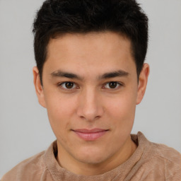 Joyful latino young-adult male with short  brown hair and brown eyes