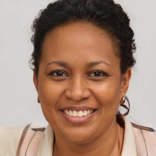Joyful latino young-adult female with short  brown hair and brown eyes